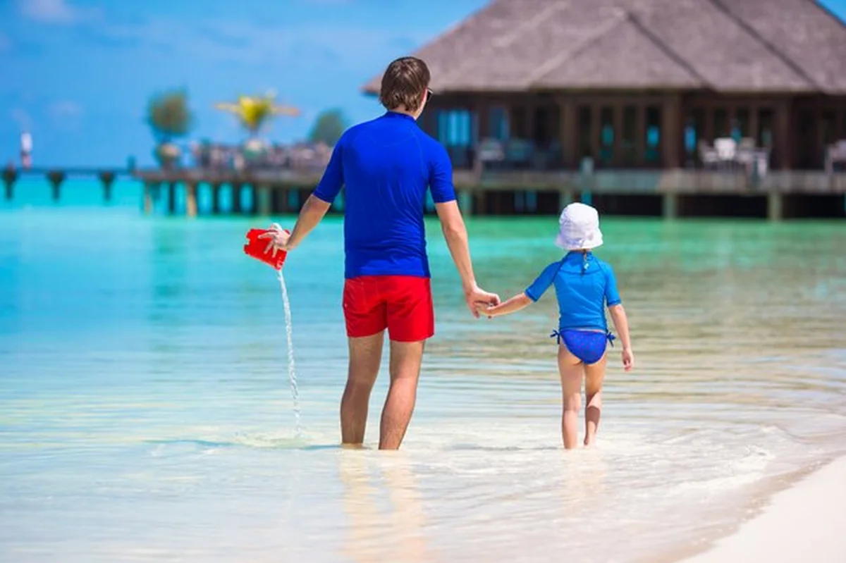 Szczęśliwa rodzina na białej plaży tropikalnej